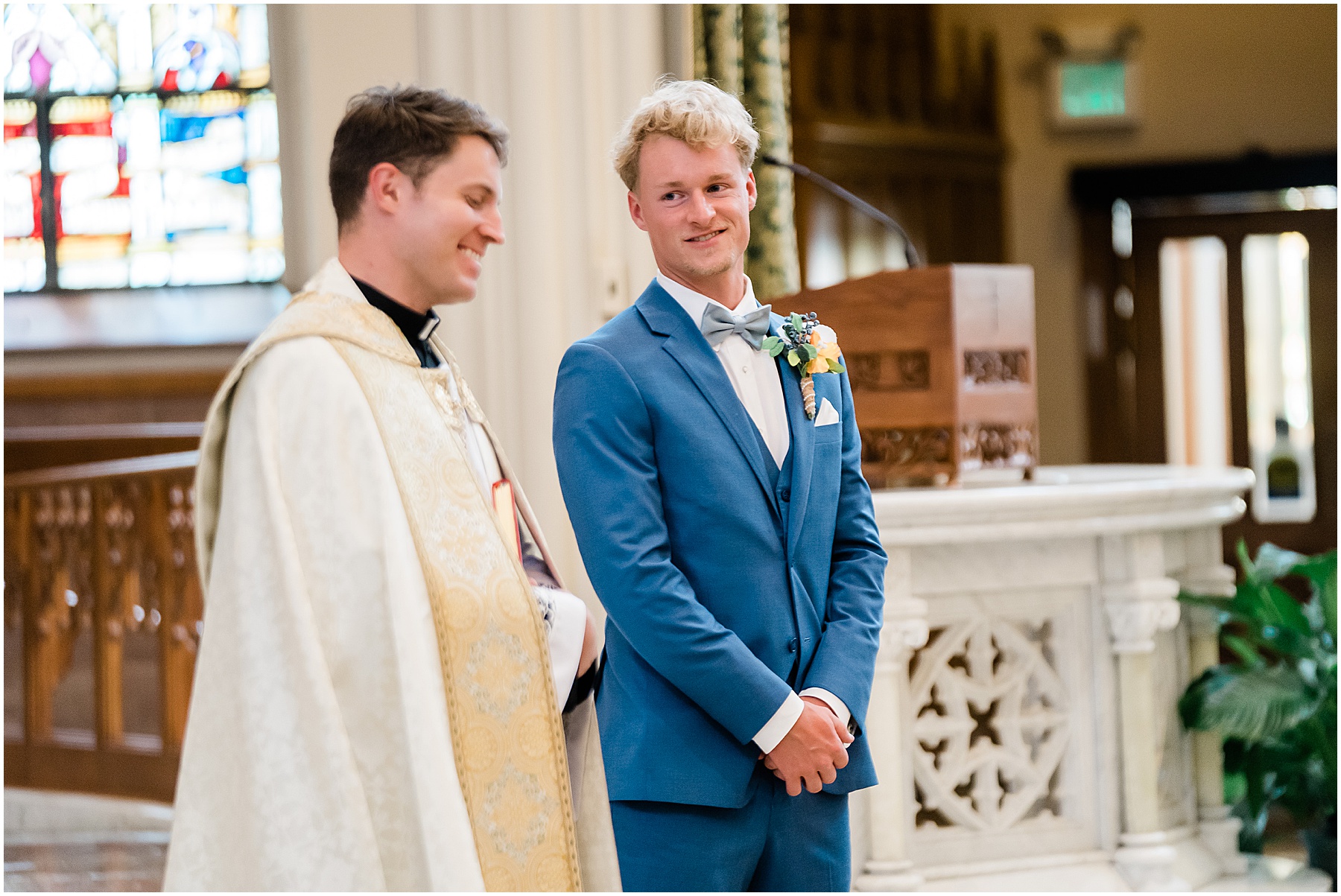 Fort Wayne wedding photographers capture groom talking to pastor before wedding ceremony