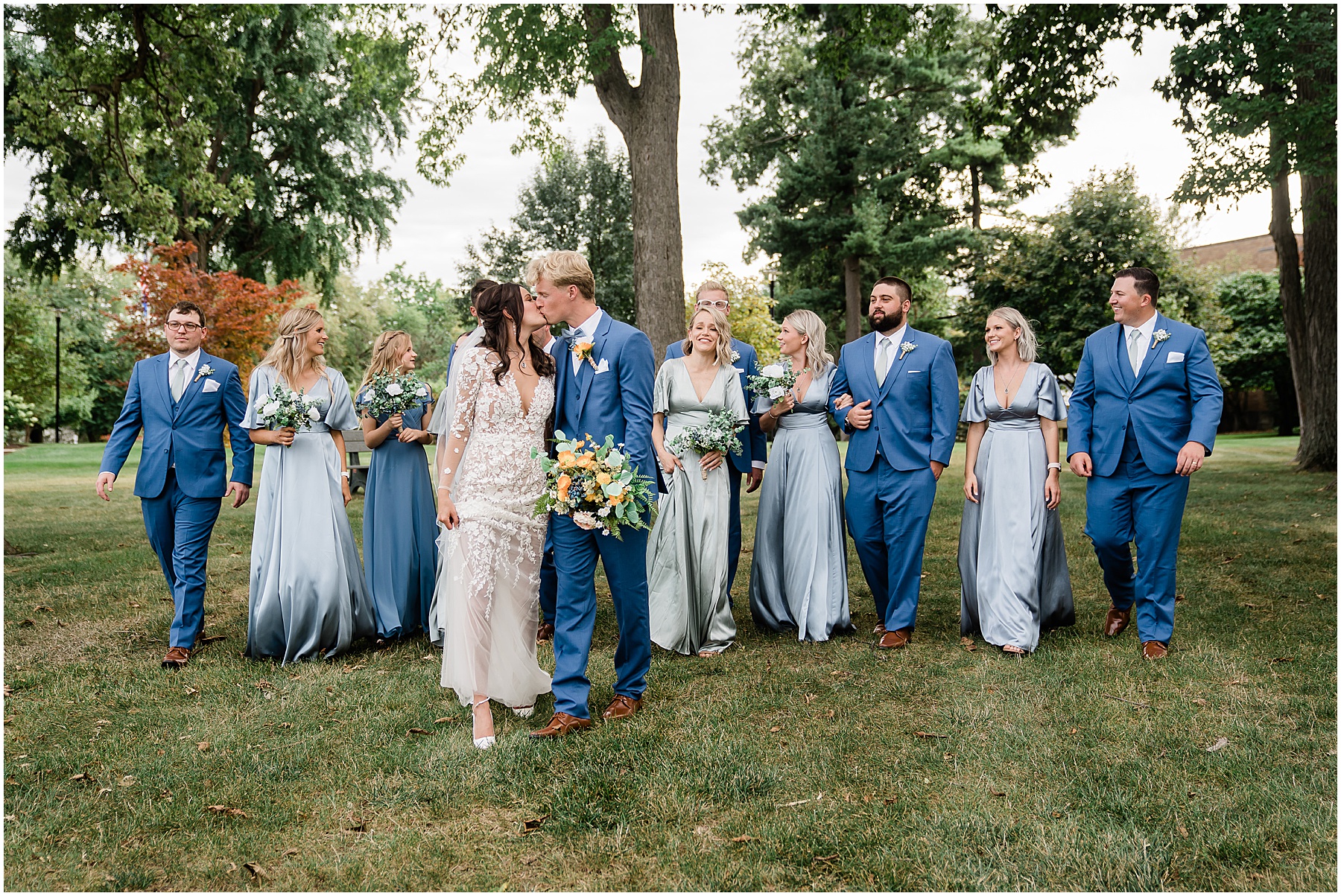 Fort Wayne wedding photographers capture bride and groom walking with wedding party