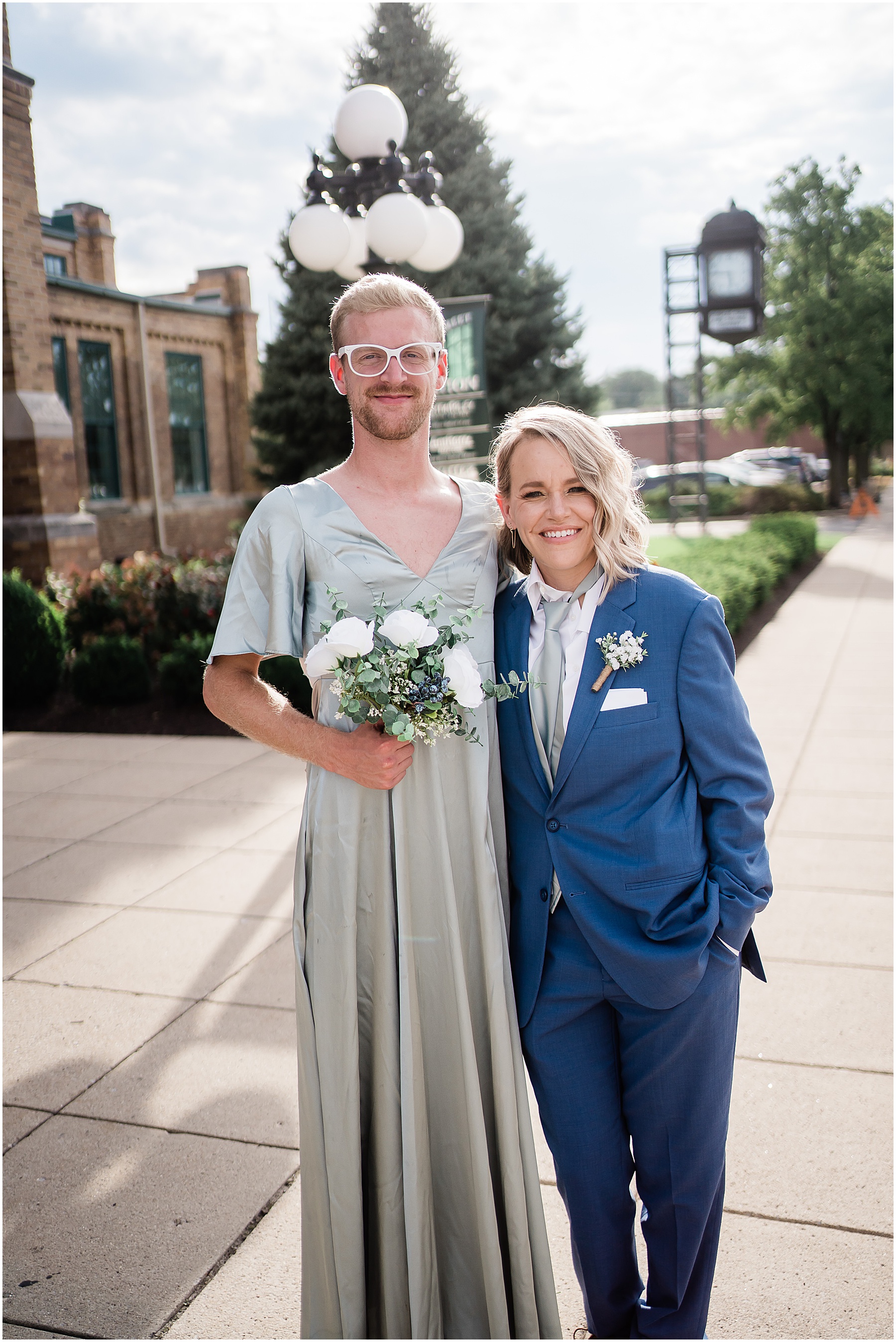 Fort Wayne wedding photographers capture groomsmen in bridesmaids dress, and bridesmaid in groomsmen suit
