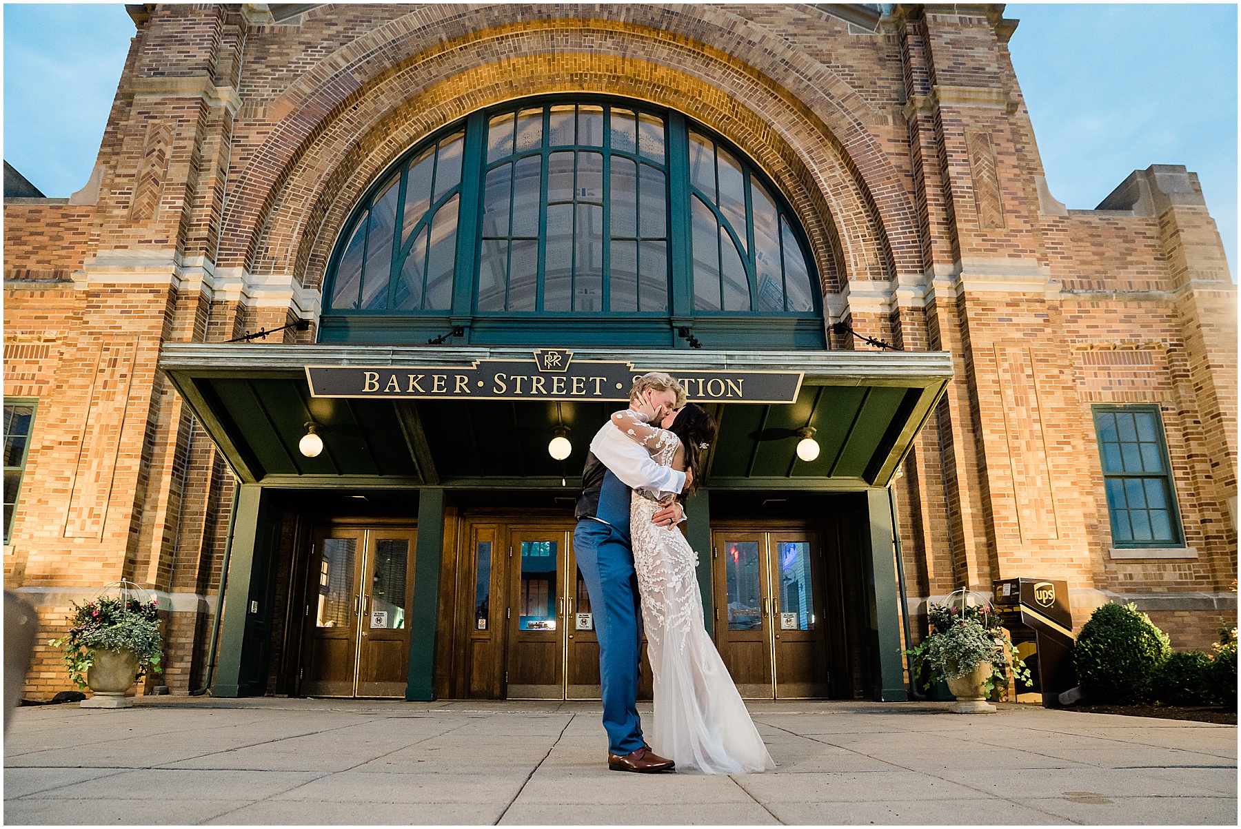 Fort Wayne wedding photographers capture bride and groom hugging outside of Baker Train Station Wedding