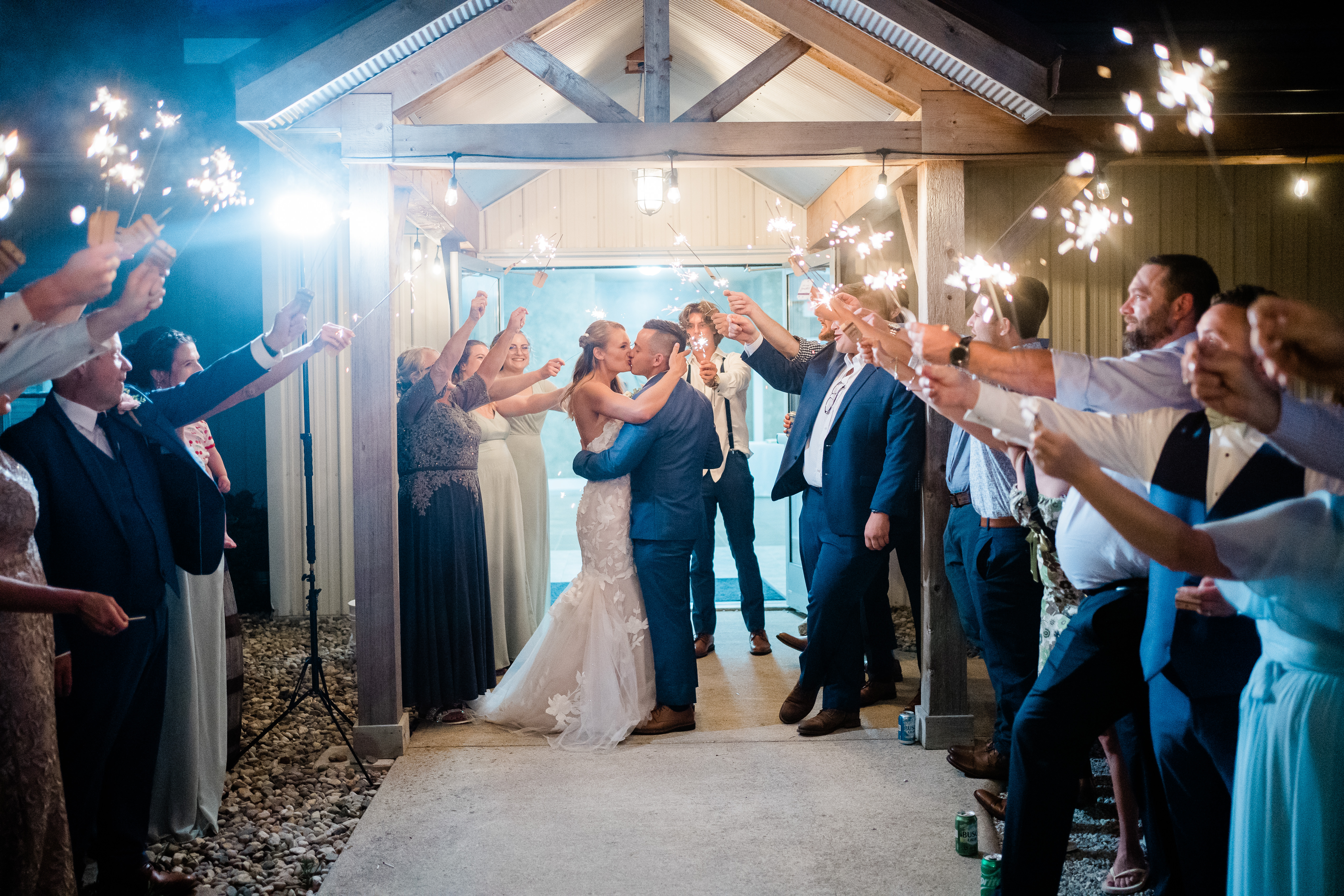 Fort wayne wedding photographers capture bride and groom kissing before sparkler wedding send off