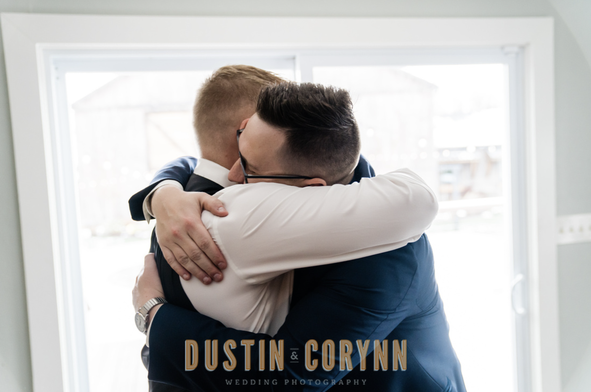 Fort wayne wedding photographer captures groom hugging groomsmen before wedding