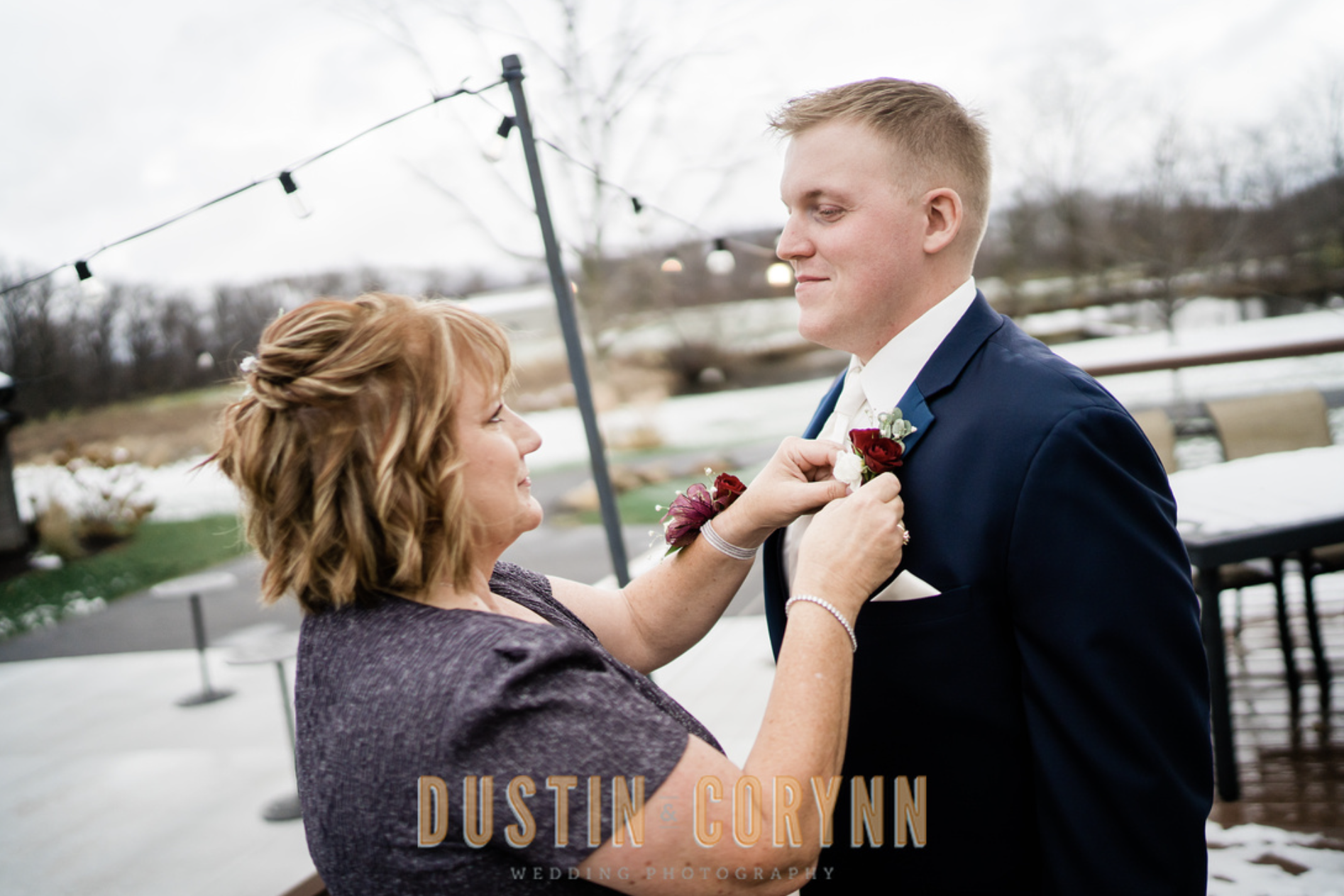 Fort Wayne wedding photographer captures groom buttoning jacket with mother
