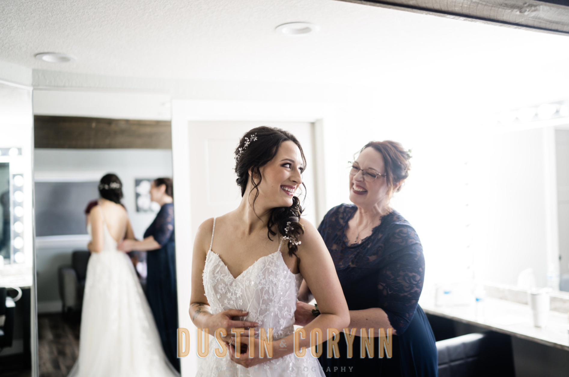 Fort Wayne wedding photographer captures bride getting buttoned into wedding gown
