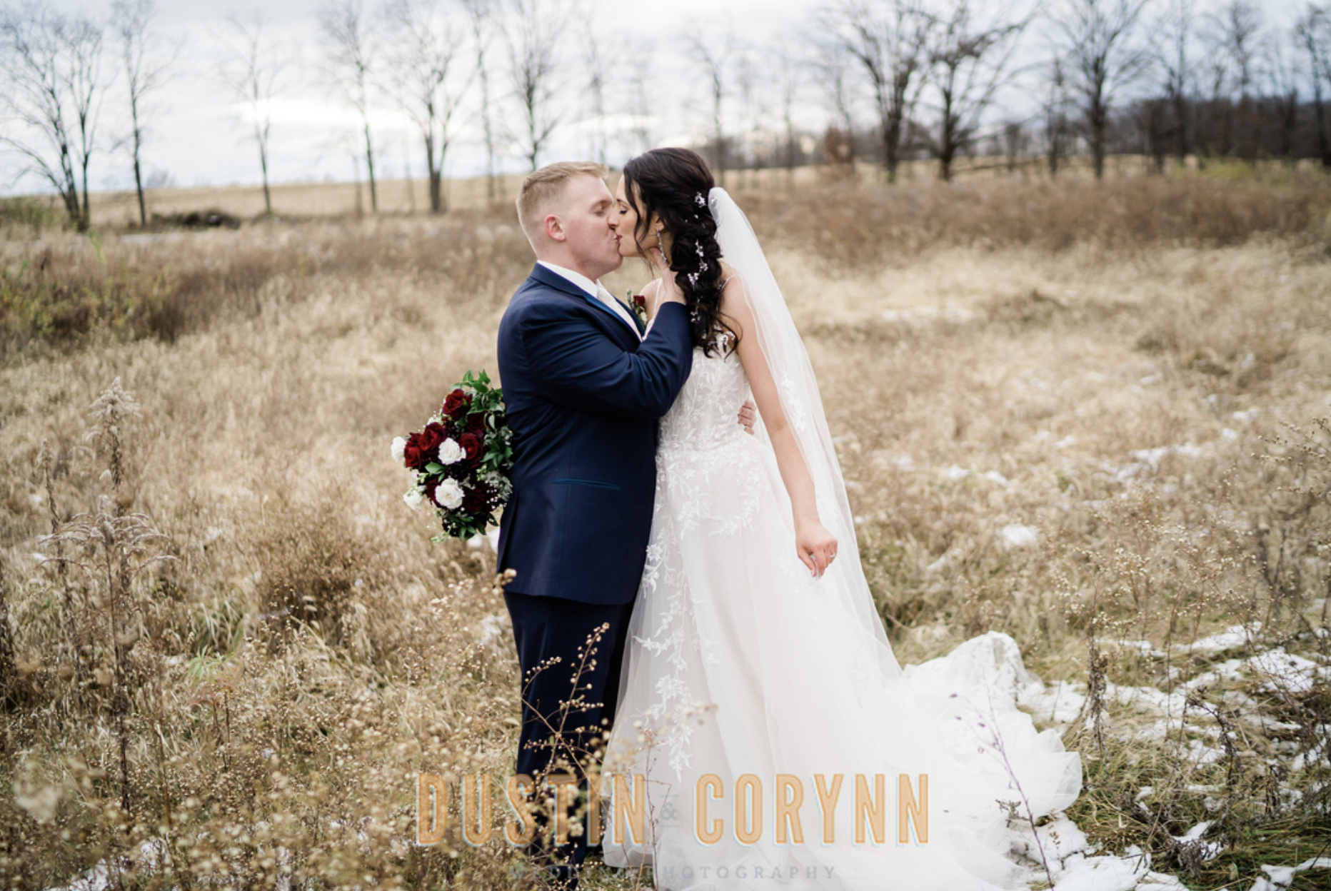Fort Wayne wedding photographer captures bride and groom kissing in field