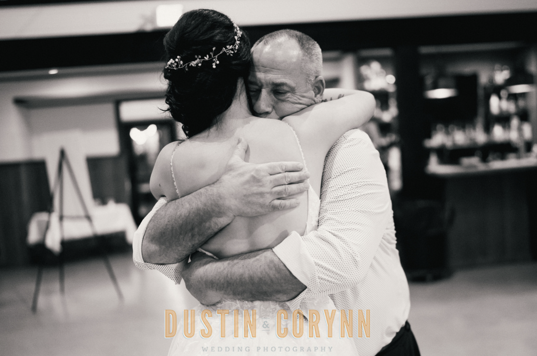 father hugging bride after father, daughter dance