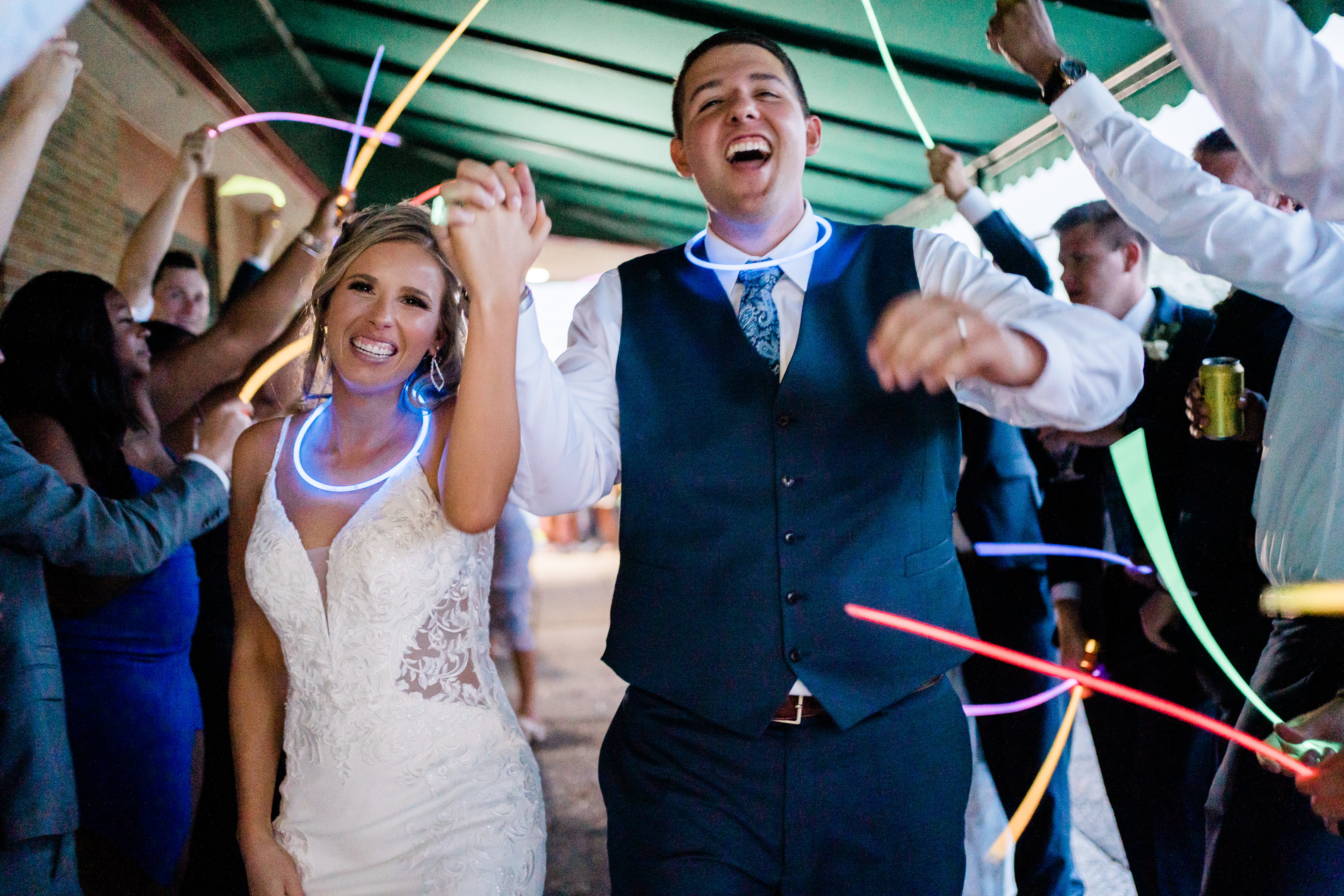 Fort Wayne wedding photographer captures bride and groom leaving wedding with wedding send off ideas - glow sticks!