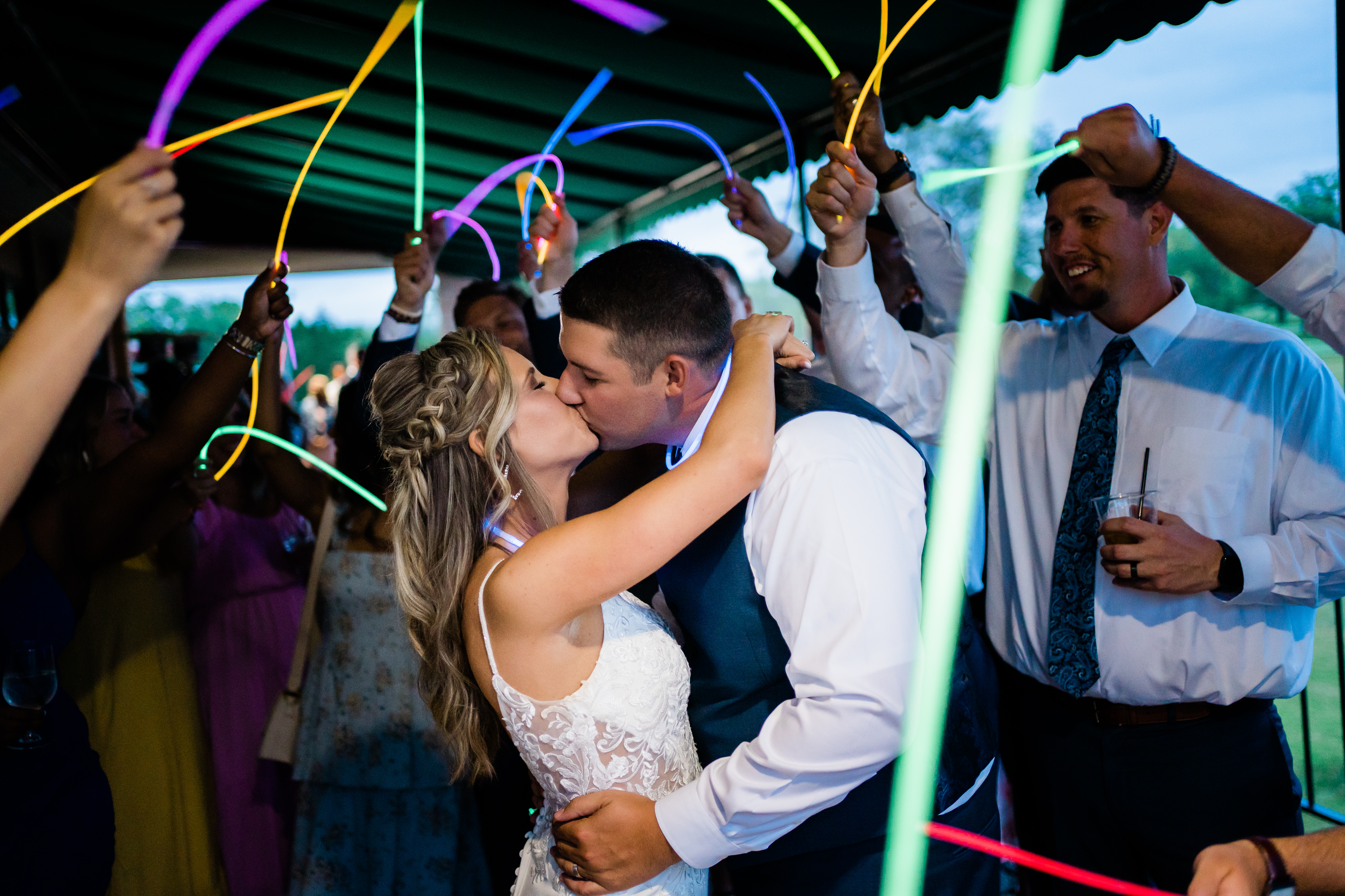 Fort Wayne wedding photographer captures bride and groom kissing during wedding send off